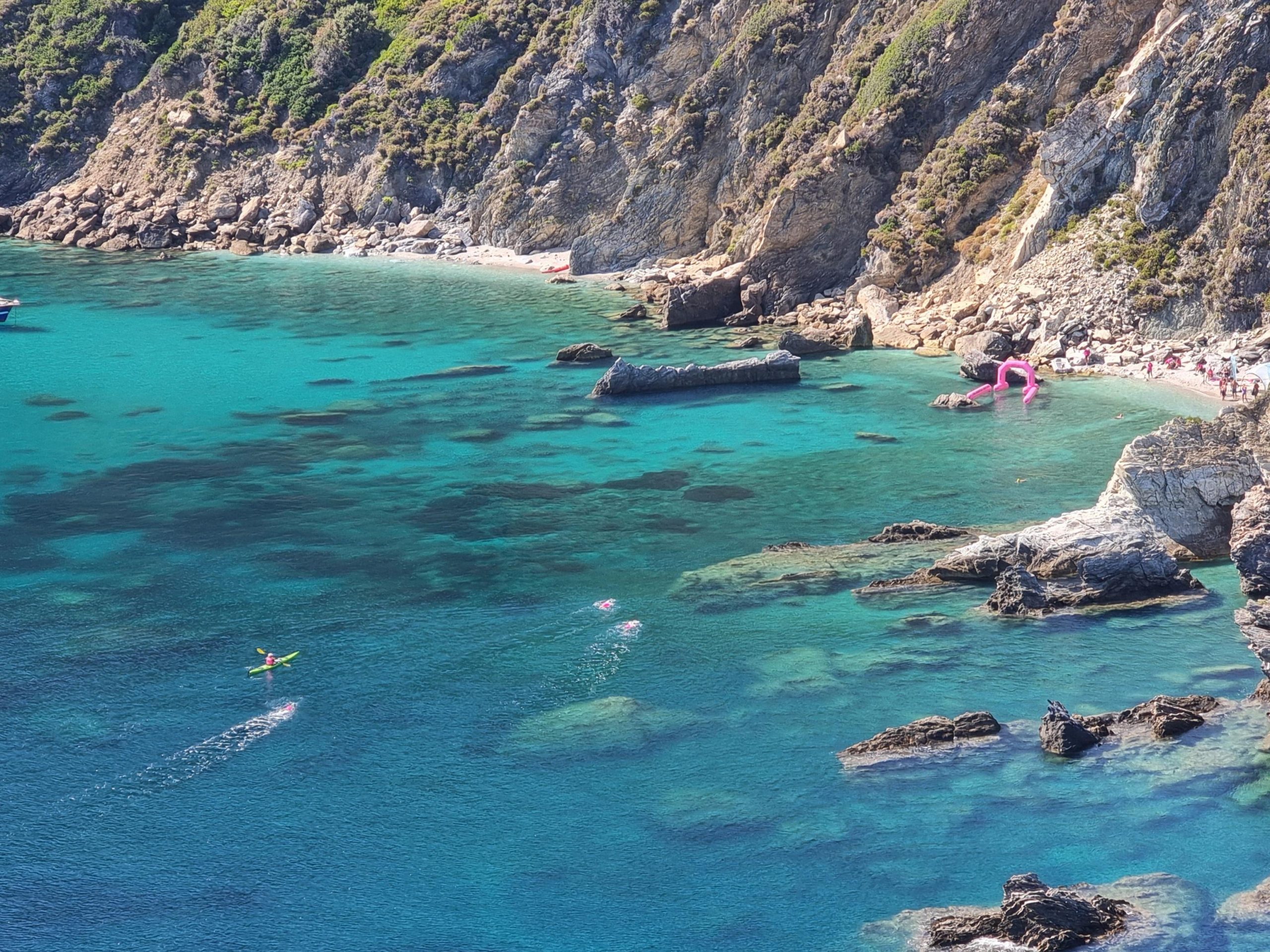 3 swimmers in the sea, seen from above and far away.