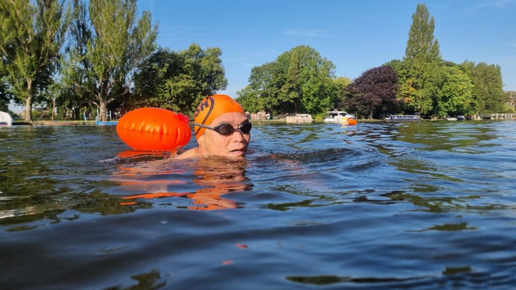 A swimmer in a river on a sunny day